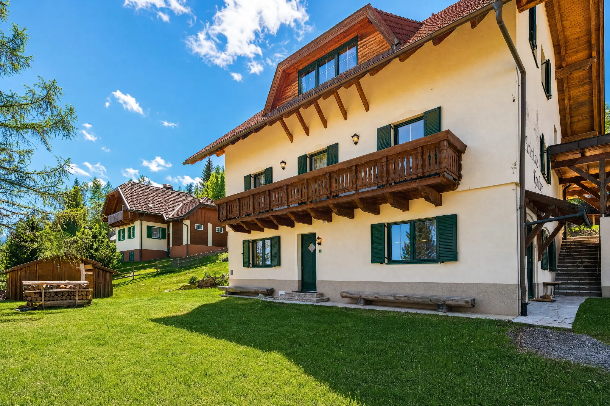 Berglodge Hochrindl — Ferienhaus Außenansicht mit Garten im Sommer